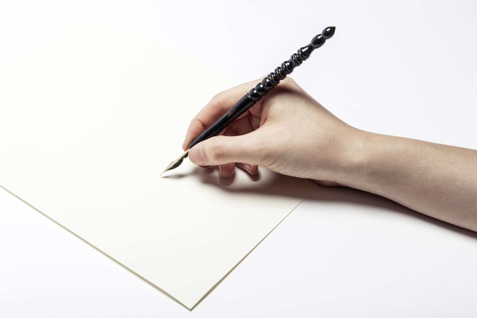 A female(woman) hand hold(write) a fountain pen and letter and ink isolated white at the studio. A female(woman) hand hold(write) a fountain pen and letter and ink isolated white at the studio.